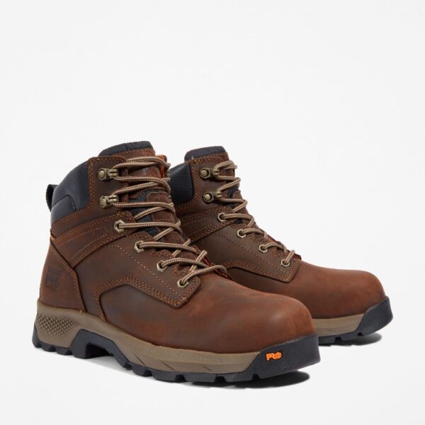 A turned pair of Timberland TiTAN EV composite toe men's 6-inch work boots in brown with a blank background.