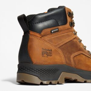 Close up of Timberland TiTAN EV non-safety toe men's 6-inch waterproof work boot in light brown showing soft toe stamp with a blank background.