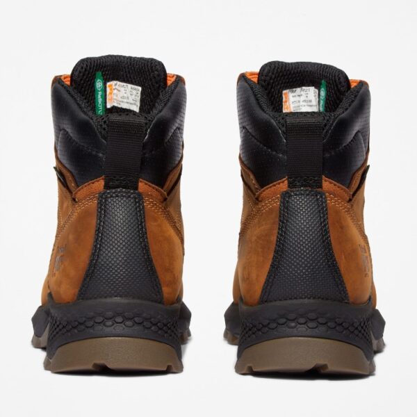 A look at the heels of a pair of Timberland TiTAN EV soft toe waterproof men's 6-inch work boots in light brown with a blank background.