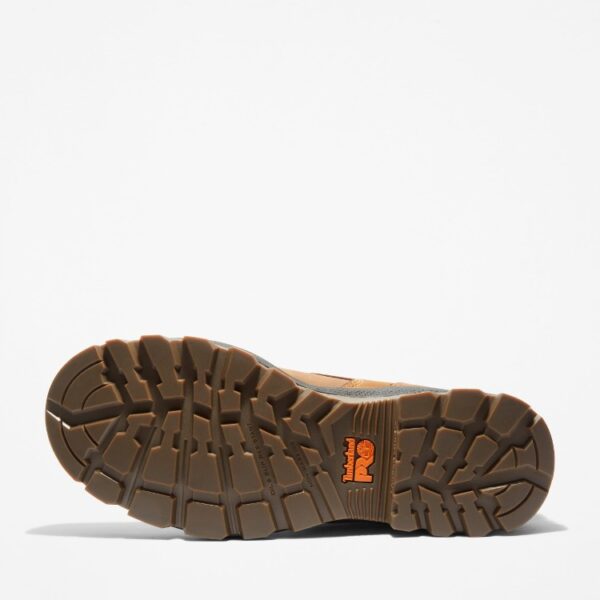 The sole of the right boot on a Timberland TiTAN EV soft toe waterproof men's 6-inch work boots in light brown with a blank background.