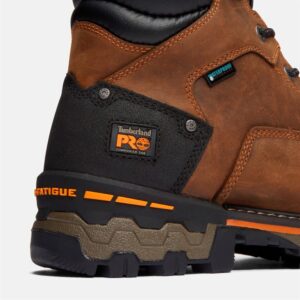 Close up of Timberland PRO Boondock safety toe 6-inch waterproof men's work boot in brown showing composite toe tag with a blank background.