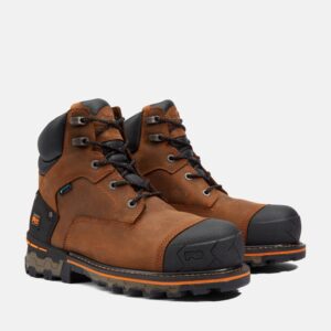 A turned pair of Timberland PRO Boondock composite toe 6-inch waterproof men's work boots in brown with a blank background.
