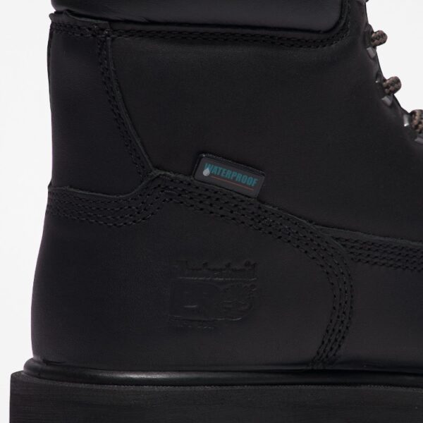 Close up of Timberland PRO Direct Attach Soft Toe Men's Work Boot in black showing waterproof tag with a blank background.