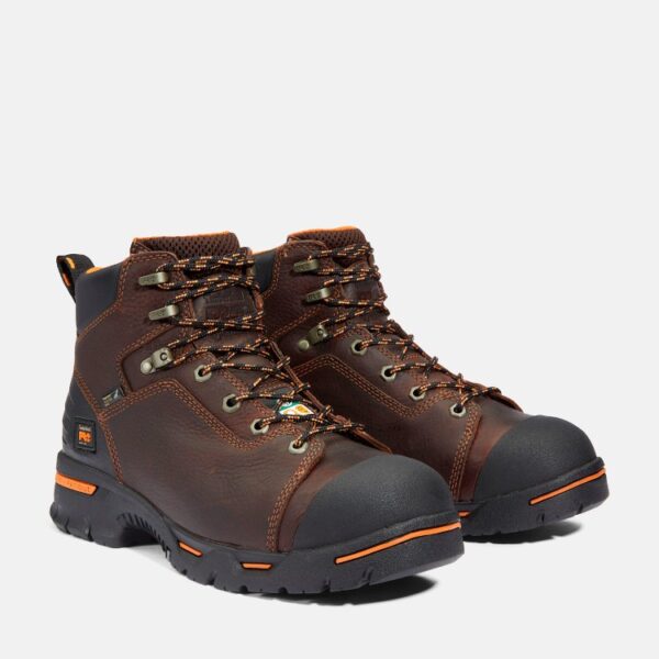 A turned pair of Timberland PRO Endurance steel toe 6-inch men's work boots in brown with a blank background.