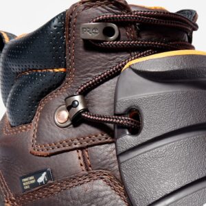 Close up of Timberland PRO Endurance Met Guard steel toe 6-inch men's work boot in brown showing puncture resistant sole tag with a blank background.