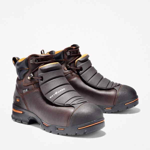 A turned pair of Timberland PRO Endurance Met Guard steel toe 6-inch men's work boots in brown with a blank background.