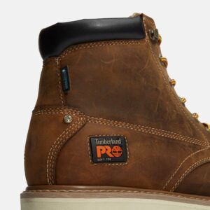 Close up of Timberland PRO Gridworks non-safety toe waterproof men's 6-inch work boot in brown showing soft toe tag with a blank background.