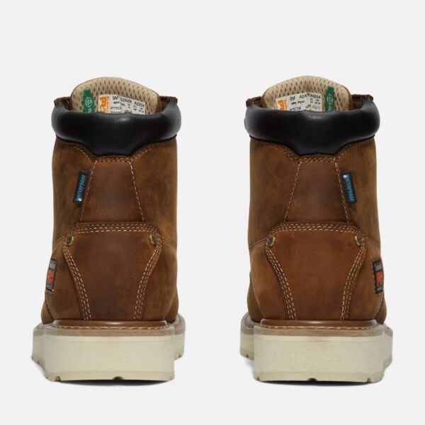 A look at the heels of a pair of Timberland PRO Gridworks soft toe waterproof men's 6-inch work boots in brown with a blank background.