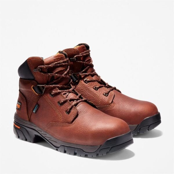 A turned pair of Timberland PRO Helix alloy toe 6-inch men's work boots in brown with a blank background.