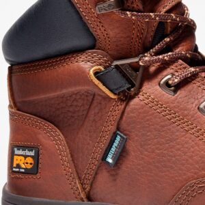 Close up of Timberland PRO Helix alloy toe 6-inch men's work boot in brown showing waterproof tag with a blank background.