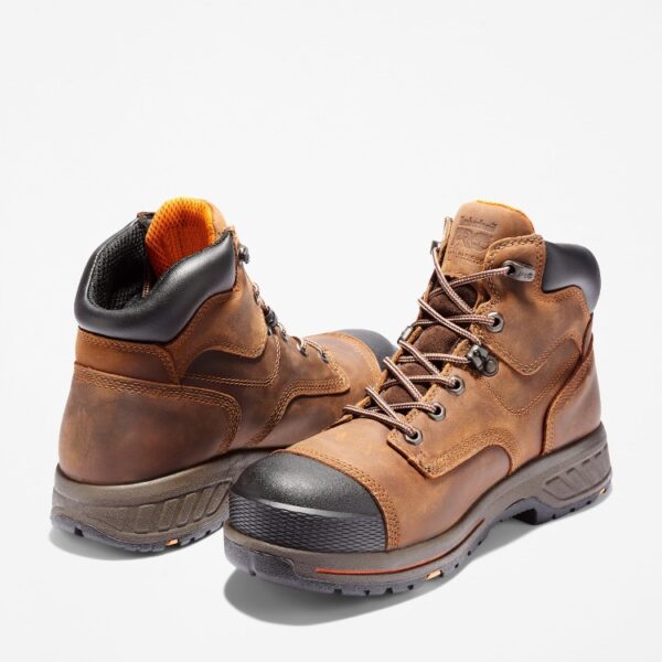 Offset pair of Timberland PRO Helix HD composite toe waterproof men's 6-inch work boots in brown with a blank background.