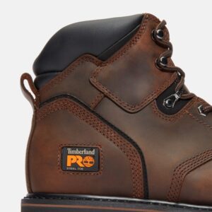 Close up of Timberland PRO Pit Boss safety toe 6-inch men's work boot in brown showing steel toe tag with a blank background.