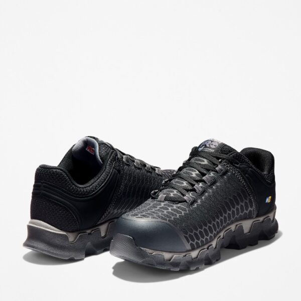Offset pair of Timberland PRO Powertrain Sport alloy toe men's work sneakers in black with a blank background.