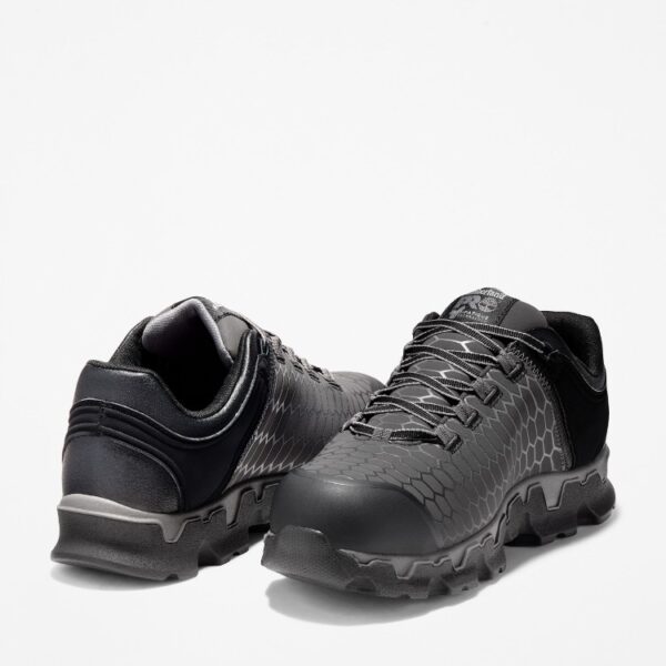 Offset pair of Timberland PRO Powertrain Sport alloy toe men's work sneakers in gray and black with a blank background.