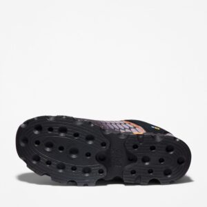 The sole of the right boot on a Timberland PRO Powertrain Sport alloy toe men's work sneakers in orange and black with a blank background.