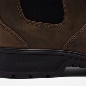 Close up of Timberland Nashoba Casual composite toe men's Chelsea work boot in brown showing Timberland PRO stamp with a blank background.
