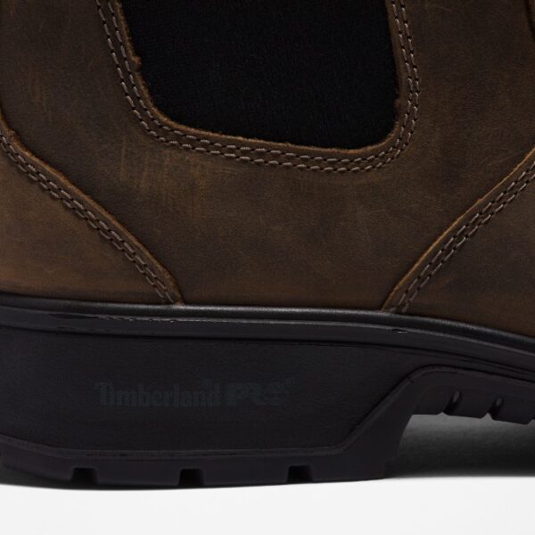 Close up of Timberland Nashoba Casual composite toe men's Chelsea work boot in brown showing Timberland PRO stamp with a blank background.