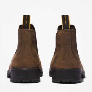A look at the heels of a pair of Timberland Nashoba Casual composite toe men's Chelsea work boots in brown with a blank background.