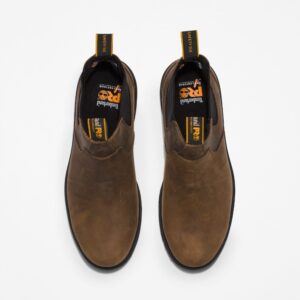 Overhead look at a pair of Timberland Nashoba Casual composite toe Chelsea men's work boots in brown on a blank background.
