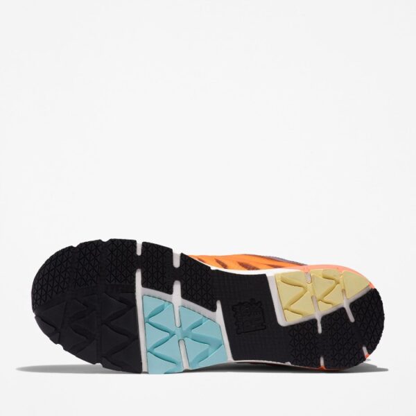 The sole of the right boot on a Timberland Radius composite toe women's work sneakers in gray, orange, black, and light blue with a blank background.
