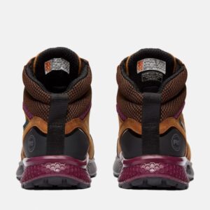 A look at the heels of a pair of Timberland Reaxion composite toe waterproof women's work sneakers in tan and purple with a blank background.
