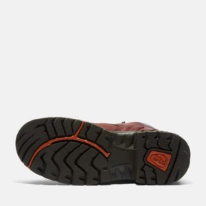 The sole of the right boot on a Timberland TiTAN alloy toe waterproof 6-inch women's work boot in brown with a blank background.