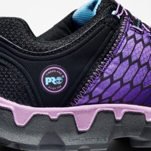 Close up of Timberland PRO Powertrain Sport safety toe women's work sneakers in purple and black showing alloy toe tag with a blank background.