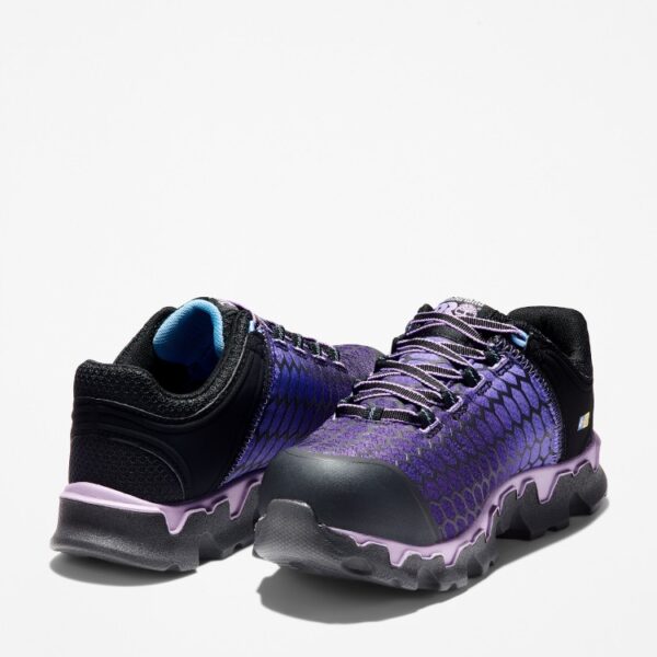 Offset pair of Timberland PRO Powertrain Sport alloy toe women's work sneakers in purple and black with a blank background.