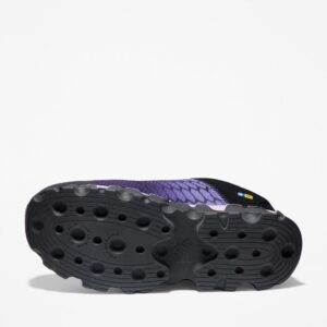The sole of the right boot on a Timberland PRO Powertrain Sport alloy toe women's work sneakers in purple and black with a blank background.