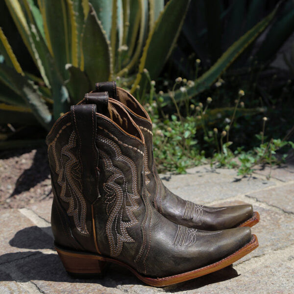 A lifestyle image of a Corral Circle G Embroidery Chocolate Ankle Snip Toe Women's Western Boot.
