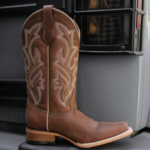 A lifestyle image of a Corral Circle G Embroidery Chocolate Wide Square Toe Women's Western Boot.