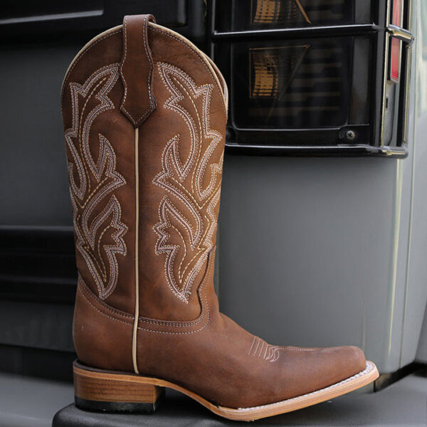 A lifestyle image of a Corral Circle G Embroidery Chocolate Wide Square Toe Women's Western Boot.