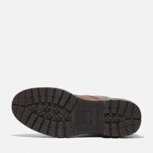 The sole of the right boot on a Timberland Montauk soft toe men's 6-inch work boots in brown with a blank background.