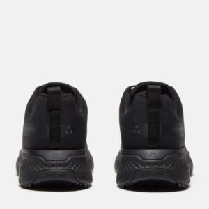 A look at the heels of a pair of Timberland Power Shift soft toe hospitality men's work sneakers in black with a blank background.