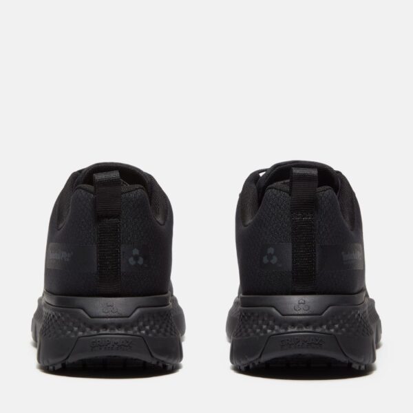 A look at the heels of a pair of Timberland Power Shift soft toe hospitality men's work sneakers in black with a blank background.