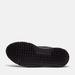 The sole of the right boot on a Timberland Power Shift soft toe hospitality men's work sneaker in black with a blank background.