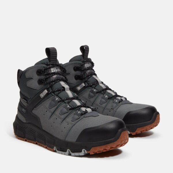 A turned pair of Timberland Tempe alloy toe waterproof men's work boots in gray with a blank background.