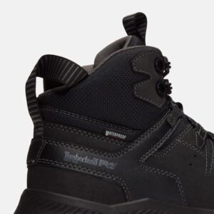 Close up of Timberland Tempe non-safety toe men's work boots in black showing soft toe stamp and waterproof tag with a blank background.