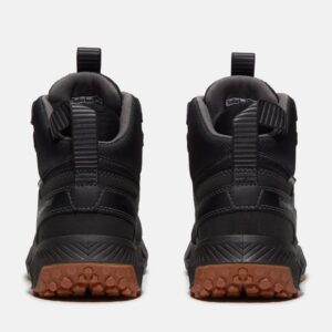 A look at the heels of a pair of Timberland Tempe soft toe waterproof 6-inch men's work boots in black with a blank background.