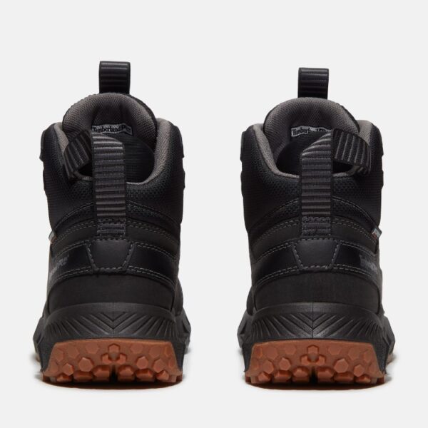 A look at the heels of a pair of Timberland Tempe soft toe waterproof 6-inch men's work boots in black with a blank background.