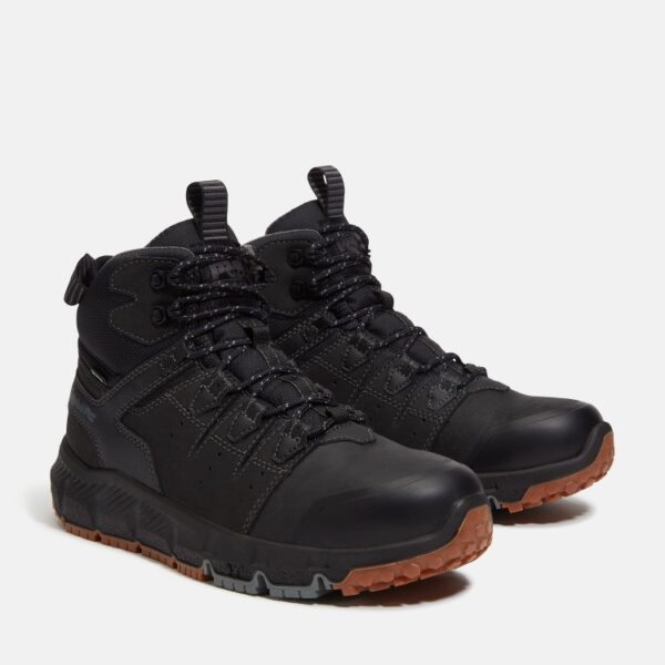 A turned pair of Timberland Tempe soft toe waterproof men's work boots in black with a blank background.