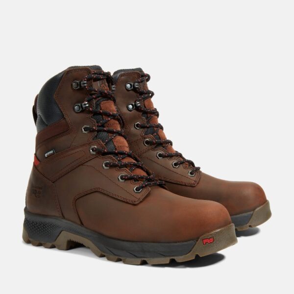 A turned pair of Timberland TiTAN EV composite toe waterproof insulated men's 8-inch work boots in brown with a blank background.