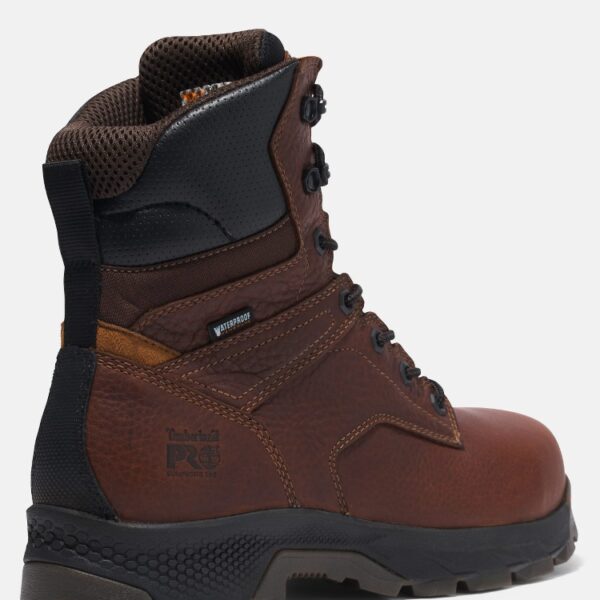 Close up of Timberland TiTAN EV safety toe men's waterproof 8-inch work boot in brown showing composite toe stamp with a blank background.