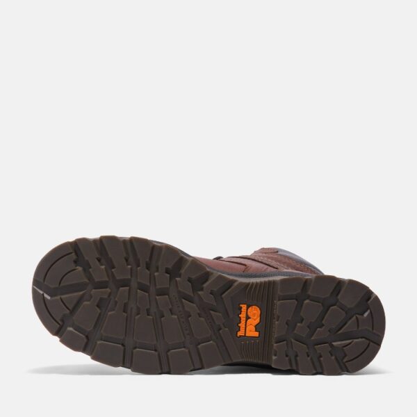 The sole of the right boot on a Timberland TiTAN EV composite toe waterproof men's 8-inch work boots in brown with a blank background.
