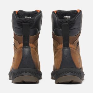 A look at the heels of a pair of Timberland TiTAN EV soft toe waterproof 8-inch men's work boots in brown with a blank background.