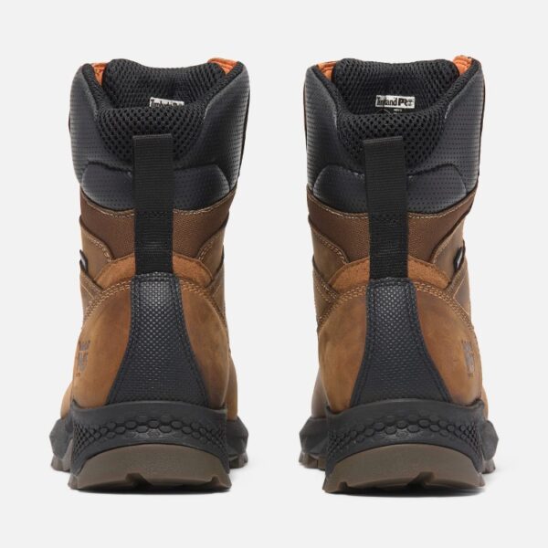 A look at the heels of a pair of Timberland TiTAN EV soft toe waterproof 8-inch men's work boots in brown with a blank background.
