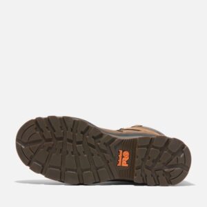 The sole of the right boot on a Timberland TiTAN EV soft toe waterproof men's 8-inch work boots in brown with a blank background.