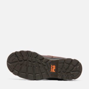 The sole of the right boot on a Timberland TiTAN EV composite toe men's Oxford work shoes in brown with a blank background.
