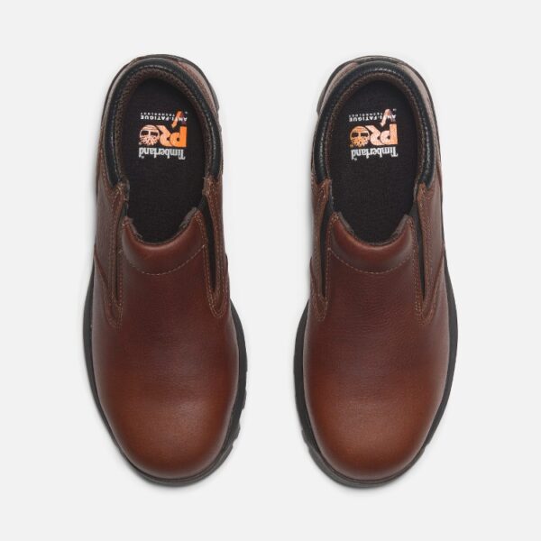 Overhead look at a pair of Timberland TiTAN EV composite toe men's slip-on work shoes in brown on a blank background.
