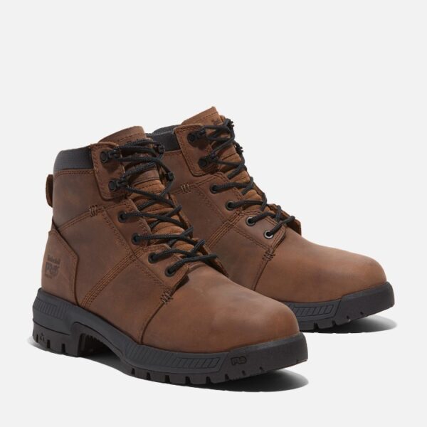 A turned pair of Timberland Montauk steel toe men's 6-inch work boots in brown with a blank background.